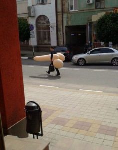 WTF man carrying plastic penis