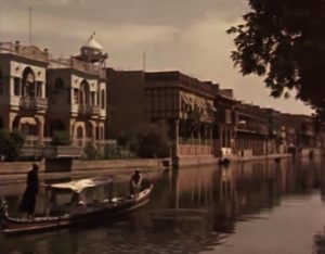 A canoe carrying merchant goods floats along the Euphrates River